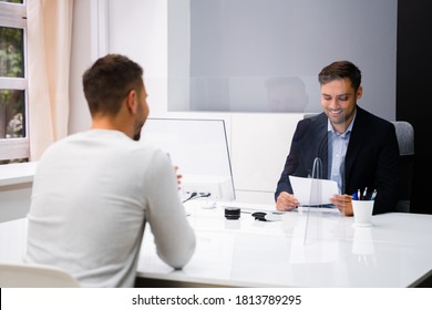 Young Man Meeting Consultant Or Lawyer With Face Masks - Powered by Shutterstock