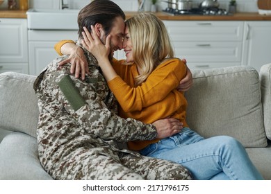 Young Man In Military Form Hugging His Wife After Coming Home From War