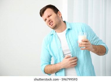 Young Man With Milk Allergy Holding Glass In Hand