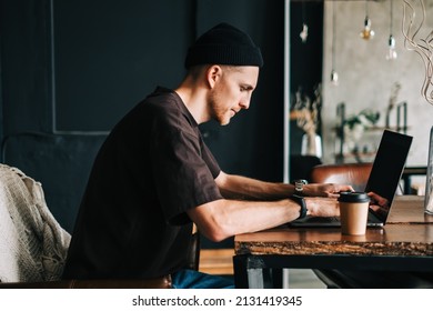Young man mobile developer writes program code on a computer, programmer work in home office. - Shutterstock ID 2131419345
