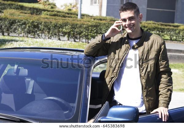 young man with a\
mobile phone and the car