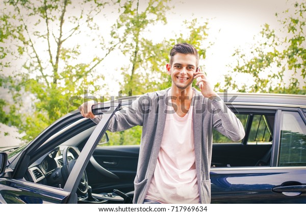 young man with mobile\
phone in the car
