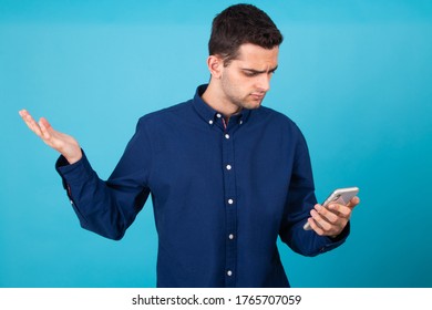 Young Man With Mobile Phone And Expression Of Incomprehension Isolated