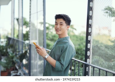 young man with mobile phone at home on the terrace - Powered by Shutterstock