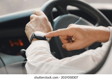 Young man with modern smart watch driving car - Powered by Shutterstock