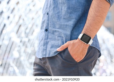Young man with modern wristwatch outdoors