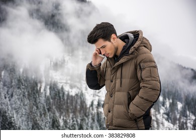 Young man in at mountain using cell phone