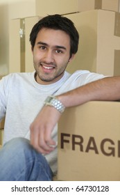Young man with moving boxes
