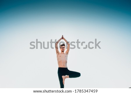 Similar – Mexican yoga teacher practicing side angle pose