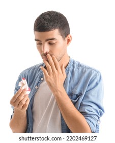 Young Man With Nosebleed And Tissue On White Background