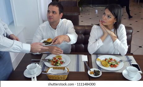 Young man not happy about his food and asking waiter to take it away - Powered by Shutterstock