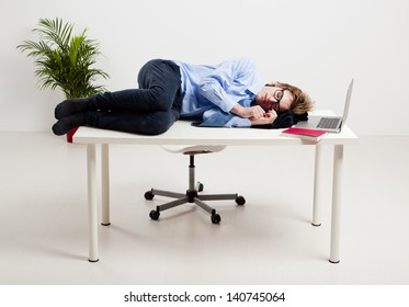 Young Man In The Office And Sleeping Over Is Desk