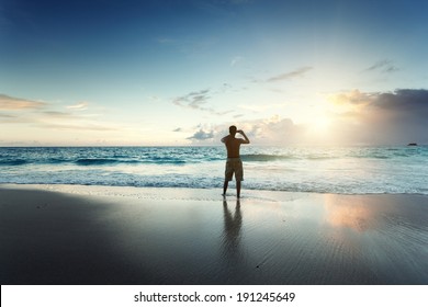 Young Man On The Beach Take Photo On Mobile Phone