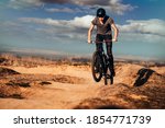 Young man on a mountain bike performing a dirt jump