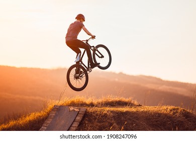 Young Man On A Mountain Bike Performing A Dirt Jump