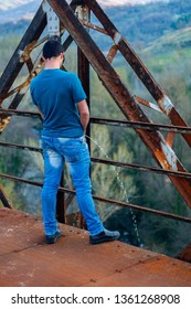 Young Man On Old Railway Bridge