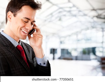 Young Man On The Phone At The Airport Saying Goodbye To His Partner While Leaving For Business