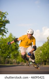 Young Man On Rollerblades Skating At Park