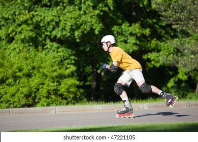 Young Man On Rollerblades Skating At Park