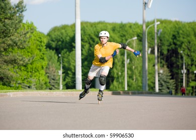 Young Man On Rollerblades Skating At Park