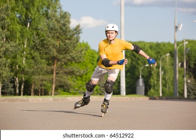 Young Man On Rollerblades Skating At Park