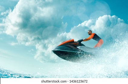 Young Man on water scooter in tropical ocean.