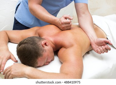 Young Man On Wellness Treatments Sports Massage