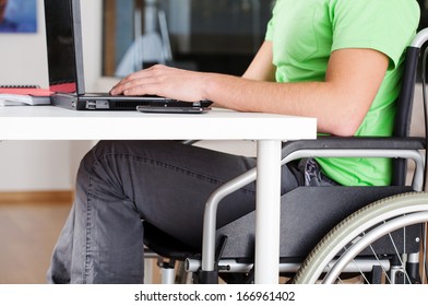 Young Man On Wheelchair Studying In His Room