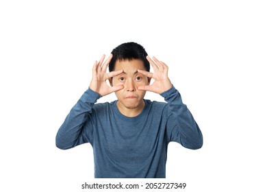 Young man open eyes with hand isolated on white background.