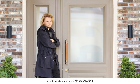 Young Man Opening The Door Of His House.Inviting The Guests