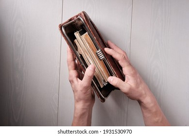 Young Man Opens A Vintage Vintage Clutch Bag With Documents