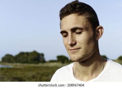 Young Man Outdoor With Closed Eyes