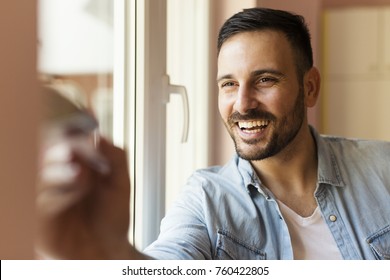 Young Man Is Painting The House With Paintbrush