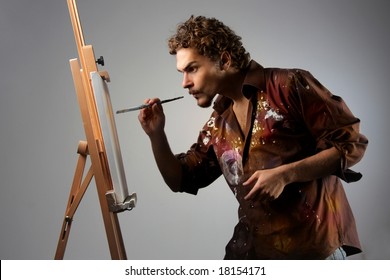 Young Man Painting On A Canvas