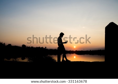 Young man in park using a mobile phone