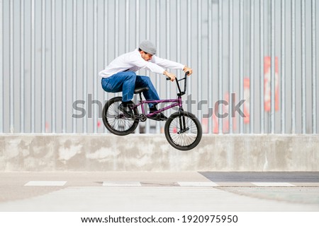 Young man performing tricks with a flatland bmx bike