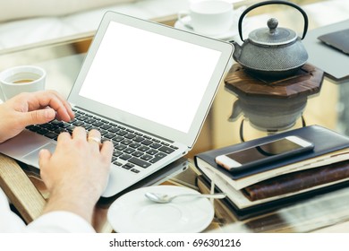 Young man performs work on a laptop