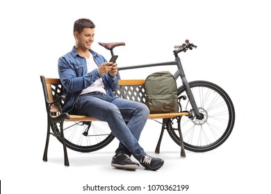 Young man with a phone and a bicycle sitting on a wooden bench isolated on white background - Powered by Shutterstock