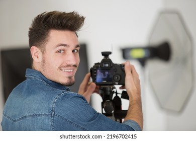 Young Man Photographer Looking At Camera