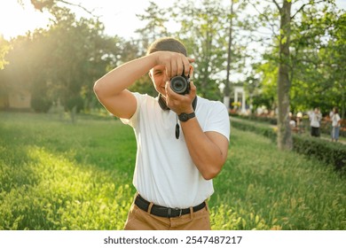 Young Man Photographer, Traveler taking photo with his camera. - Powered by Shutterstock