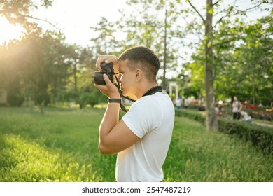 Young Man Photographer, Traveler taking photo with his camera. - Powered by Shutterstock