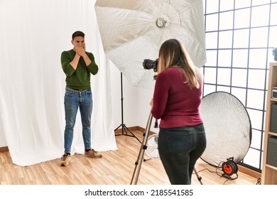 Young Man At Photography Studio Shocked Covering Mouth With Hands For Mistake. Secret Concept. 