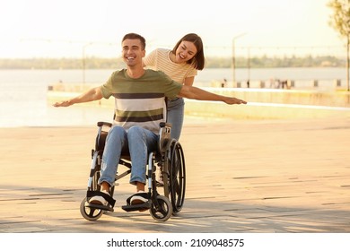 Young man with physical disability and his wife outdoors - Powered by Shutterstock