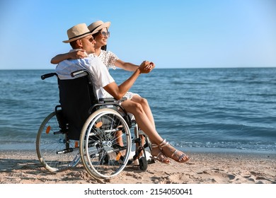 Young man with physical disability and his girlfriend at sea resort - Powered by Shutterstock