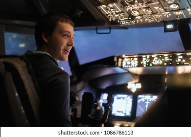 Young Man Piloting A Plane In Flight Simulator For The Training Of The Pilots