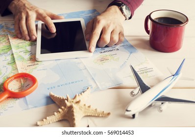 Young Man Planning Travel Vacation Trip With Map