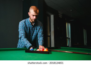 Young Man Playing Billiards In The Dark Billiard Club