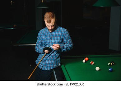 Young Man Playing Billiards In The Dark Billiard Club