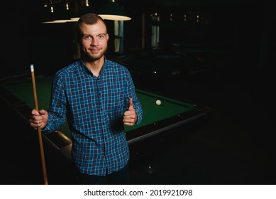 Young Man Playing Billiards In The Dark Billiard Club