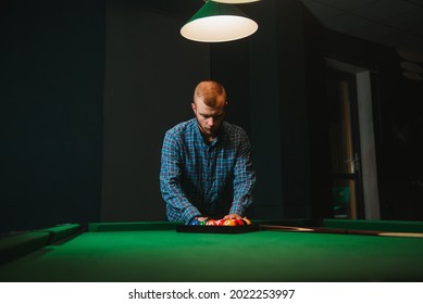 Young Man Playing Billiards In The Dark Billiard Club